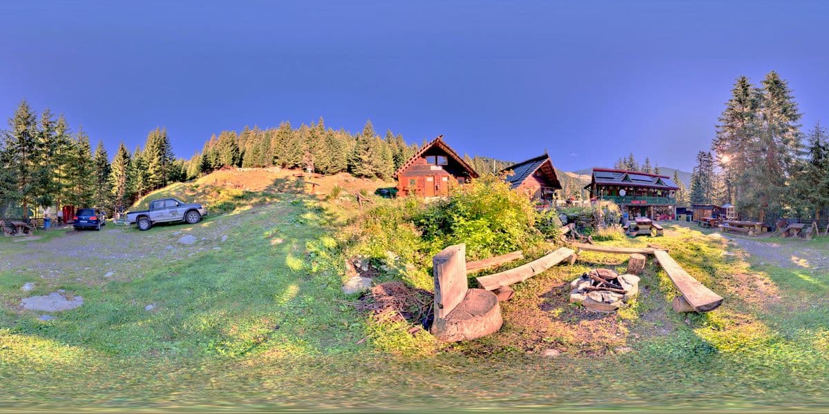 The fire pit, with wooden benches and the houses behind